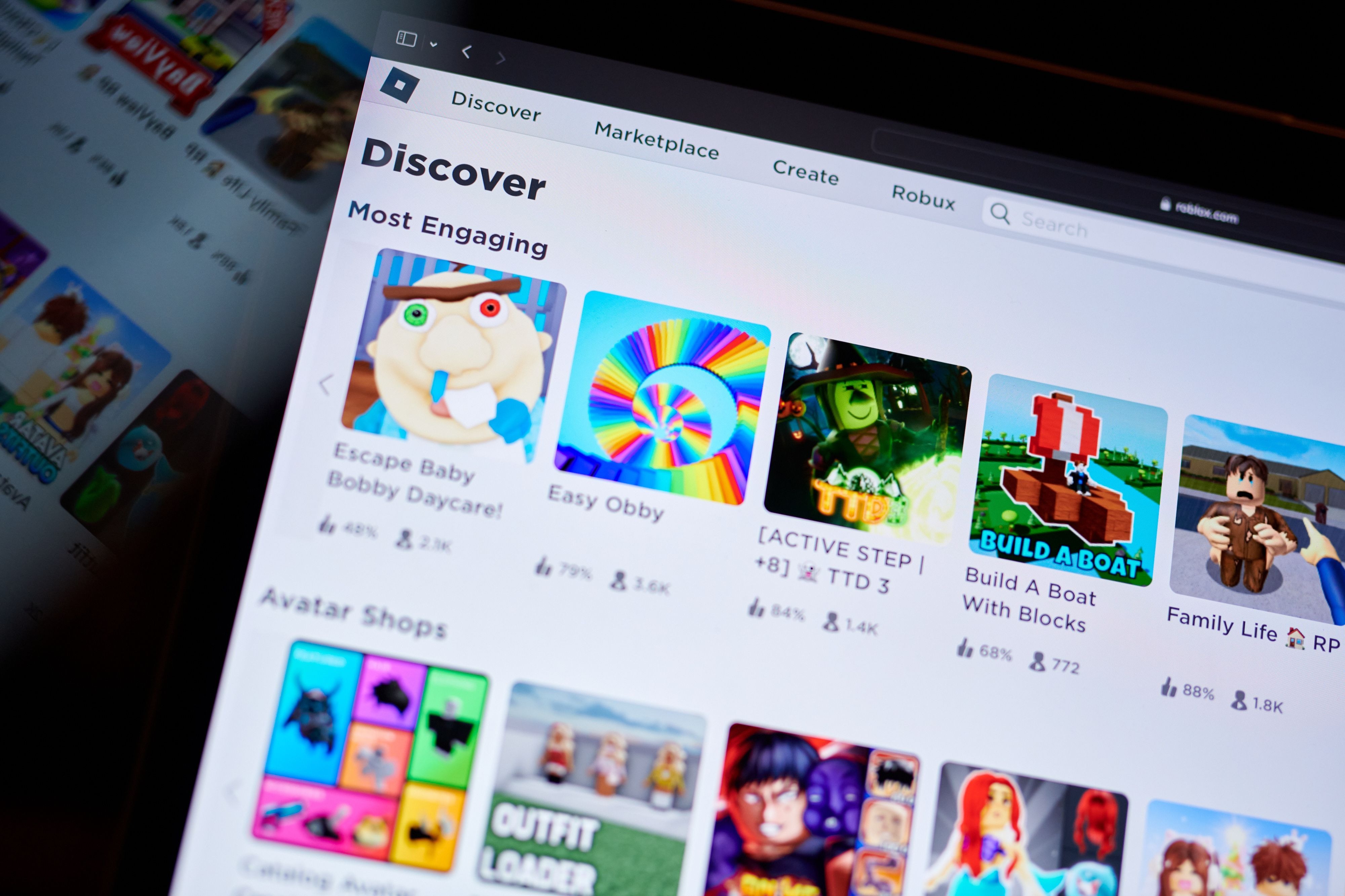 Child using tablet with Roblox on screen